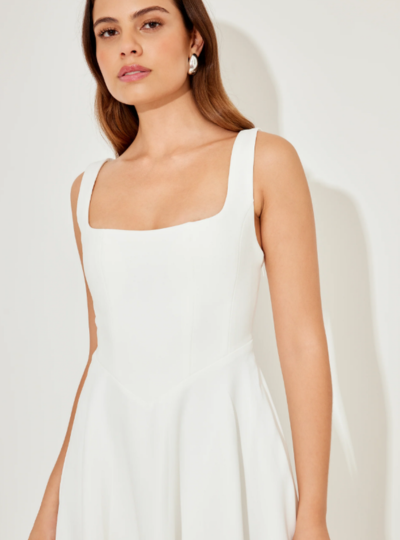 A woman in a sleeveless halter dress