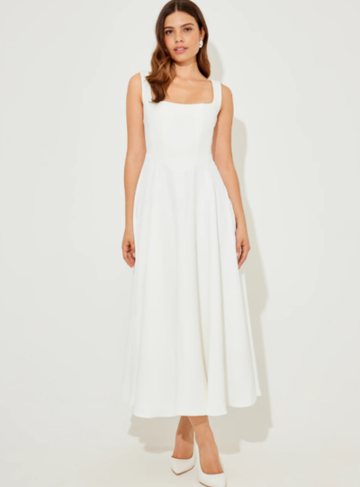 A woman in a sleeveless halter dress