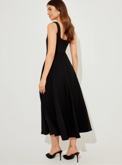 A woman in a sleeveless halter dress