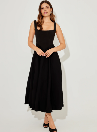 A woman in a sleeveless halter dress